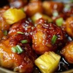 Brown Sugar Pineapple Chicken on a modern marble countertop, showcasing its glossy glaze and golden pineapple chunks.