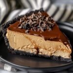 Espresso Coffee Cheesecake on a marble countertop, showcasing its creamy espresso filling and rich Oreo crust with chocolate ganache.
