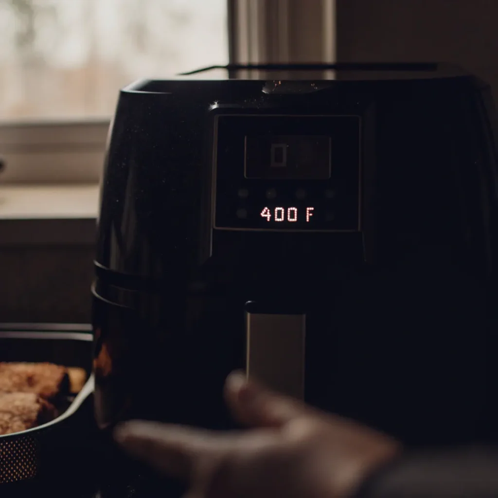 Preheating air fryer for frozen French toast sticks - step 1 showing digital display set to 400°F with empty basket pulled out.